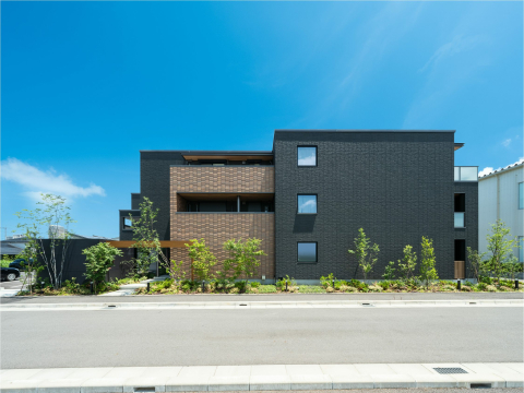 区画整理エリアにて相続対策を見据えた土地活用の事例です。
屋内共用空間によりホテルライクな高級感を演出し、周辺物件からの差別化を強調しました。

東西南に接道する好条件を生かし、黒基調のシンプルな外観デザインと木目のゲート、土壁風のタイルを配置することで和モダンな雰囲気を演出しました。